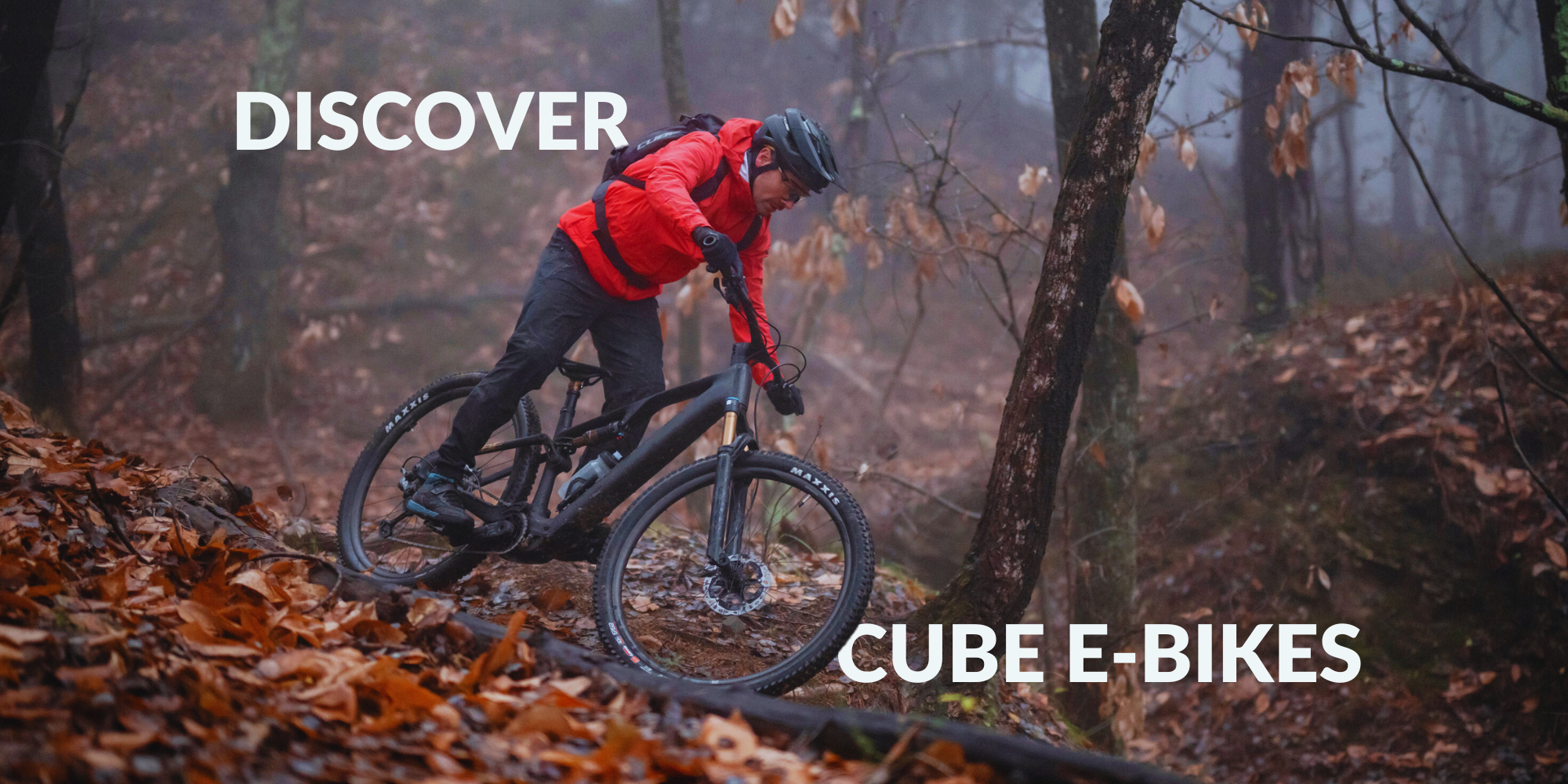 Cube Stereo Hybrid electric Mountain Bike riding through forest by All Terrain Cycles UK